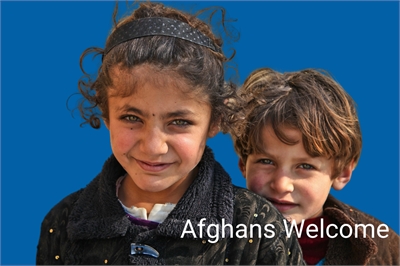 [ai] Two children smiling at the camera, with the girl in front wearing a black jacket and the boy behind with tousled hair. A blue background features the text "Afghans Welcome."
